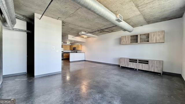 below grade area with radiator, visible vents, and baseboards