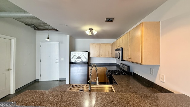 kitchen with a sink, stainless steel appliances, visible vents, light brown cabinets, and dark countertops