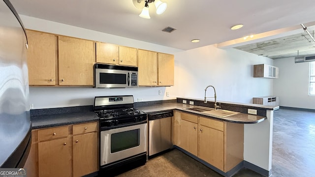 kitchen with concrete floors, a peninsula, a sink, visible vents, and appliances with stainless steel finishes