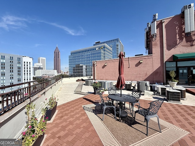 view of patio / terrace with central air condition unit and a city view