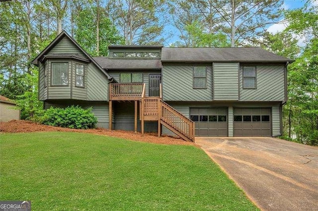 view of front of home featuring driveway, stairway, an attached garage, and a front yard
