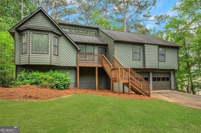 view of front of home with stairway, driveway, a garage, and a front yard