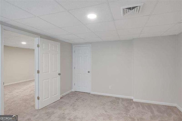 finished below grade area featuring baseboards, visible vents, and carpet floors
