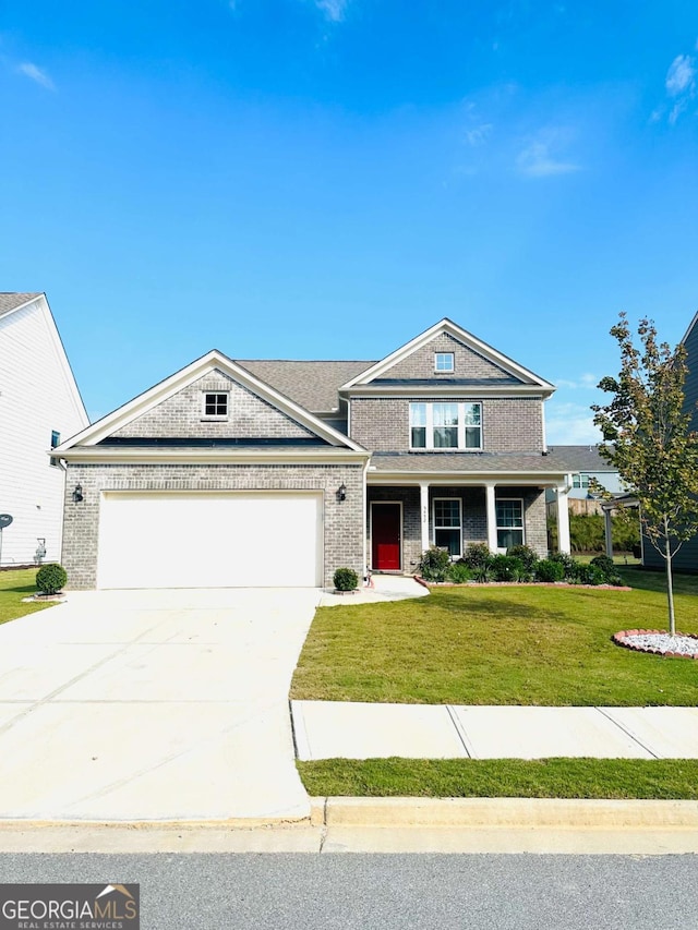 5452 Fountainhead Ln, Auburn, GA 30011 - view of front of home with covered porch, a garage, a front yard, brick siding, and driveway