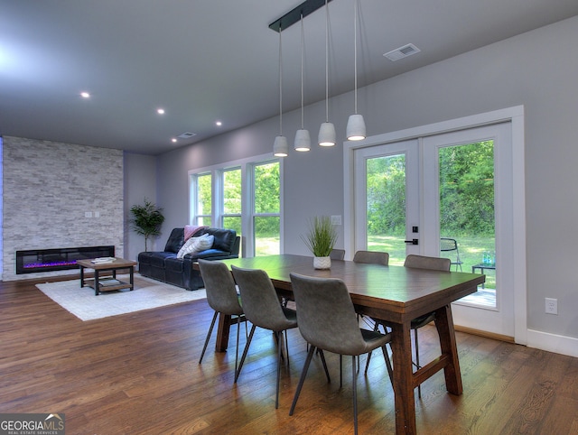 419 Mcinnes Cir SE, Marietta, GA 30060 - dining space with dark wood-style floors, a stone fireplace, and baseboards