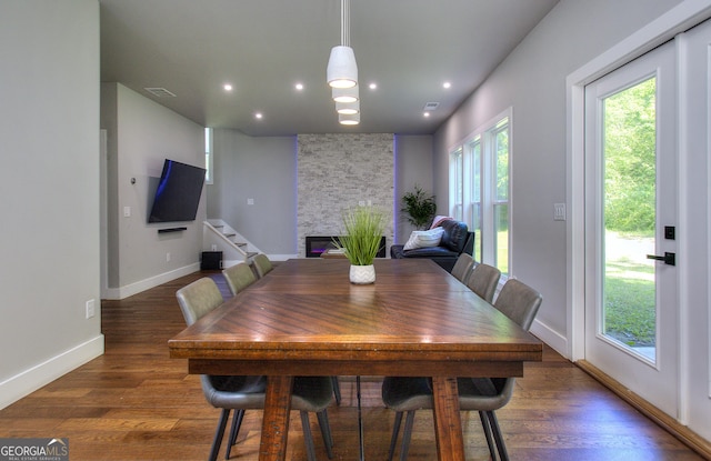 419 Mcinnes Cir SE, Marietta, GA 30060 - dining space featuring a stone fireplace, wood finished floors, stairs, baseboards, and recessed lighting