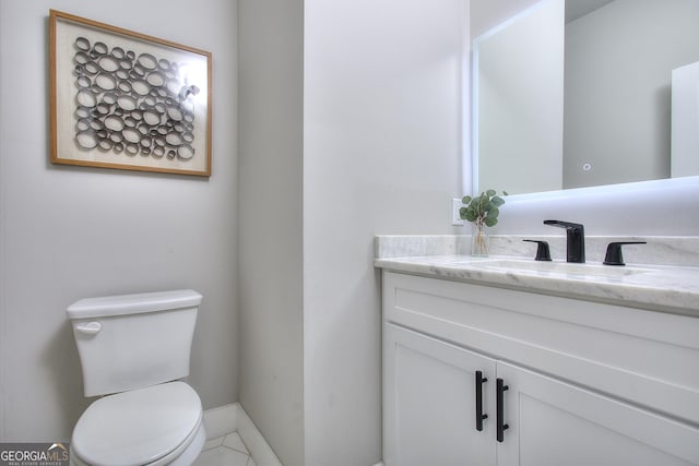 419 Mcinnes Cir SE, Marietta, GA 30060 - half bath featuring vanity, toilet, baseboards, and tile patterned flooring