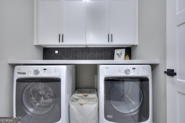 419 Mcinnes Cir SE, Marietta, GA 30060 - laundry area featuring washer and clothes dryer and cabinet space