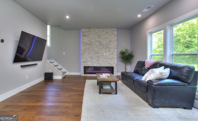 419 Mcinnes Cir SE, Marietta, GA 30060 - living room featuring healthy amount of natural light, wood finished floors, stairway, a stone fireplace, and recessed lighting