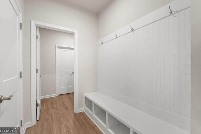 mudroom featuring light wood-style floors and baseboards
