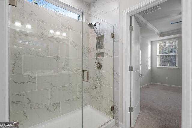 full bathroom with a stall shower, baseboards, visible vents, and crown molding