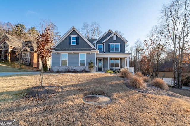 craftsman-style house featuring board and batten siding, a porch, and a front lawn