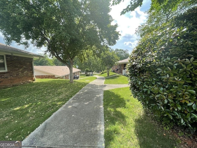 view of home's community with a lawn