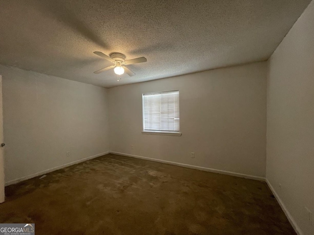 carpeted spare room with a ceiling fan, baseboards, and a textured ceiling
