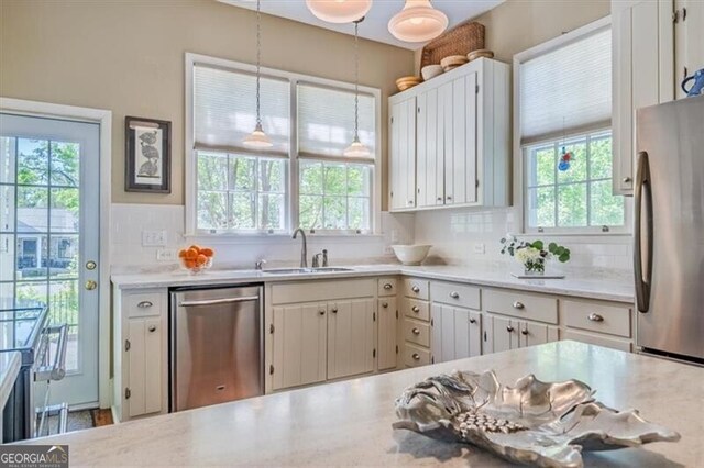 kitchen with a wealth of natural light, stainless steel appliances, and a sink