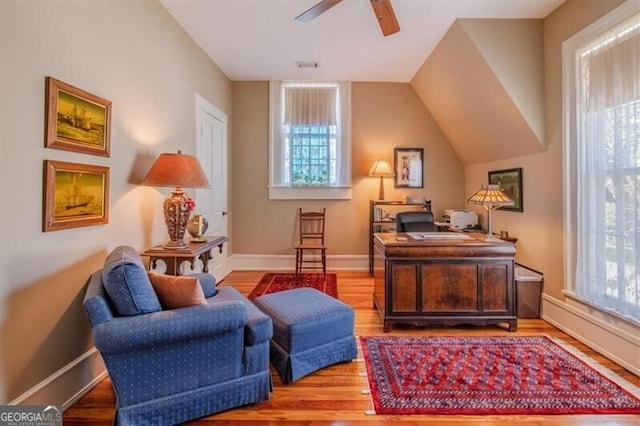 office with ceiling fan, a wealth of natural light, visible vents, and wood finished floors