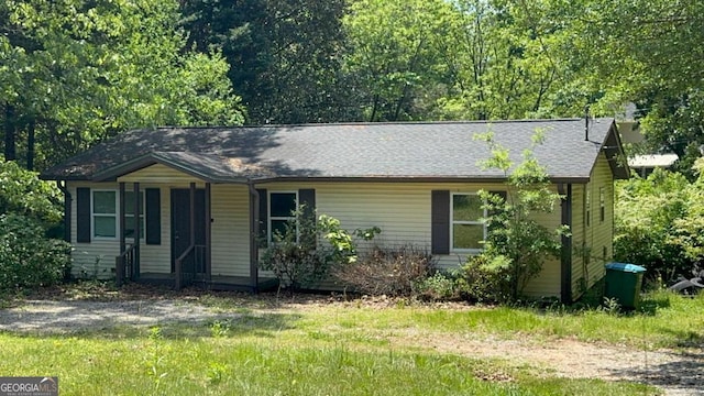 single story home featuring a shingled roof