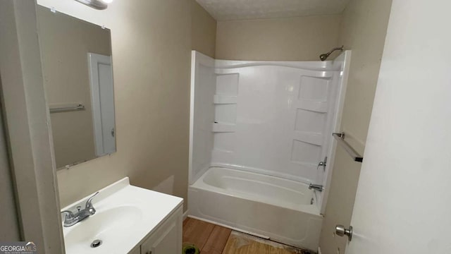 bathroom with vanity, tub / shower combination, and wood finished floors