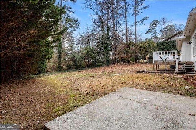 view of yard with a deck and a patio area