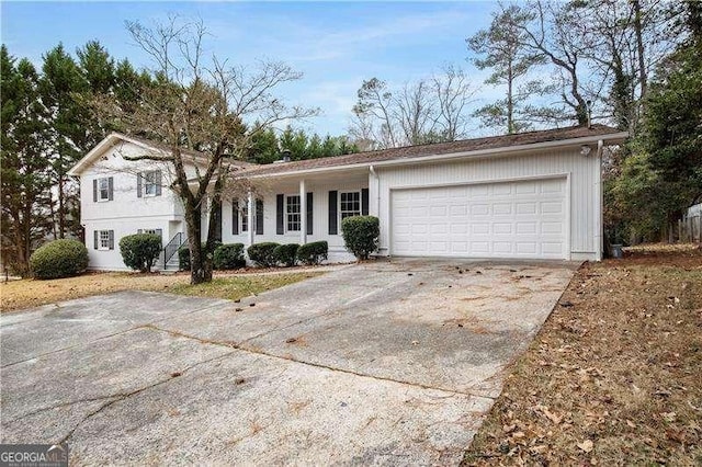 split level home with concrete driveway and a garage
