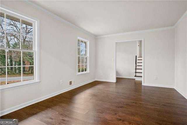 unfurnished room with baseboards, plenty of natural light, and dark wood-type flooring