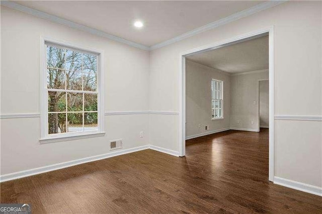 unfurnished room featuring wood finished floors, ornamental molding, visible vents, recessed lighting, and baseboards