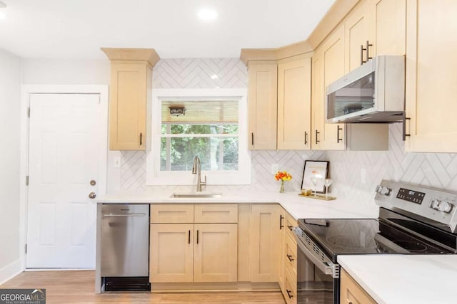2260 Old Spring Rd SE, Smyrna, GA 30080 - kitchen with appliances with stainless steel finishes, light wood finished floors, light countertops, and backsplash
