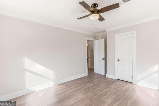 2260 Old Spring Rd SE, Smyrna, GA 30080 - unfurnished bedroom with crown molding, wood finished floors, and a ceiling fan
