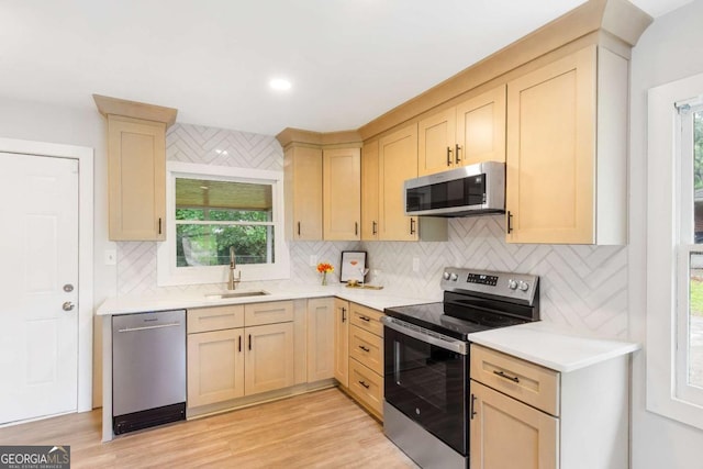 2260 Old Spring Rd SE, Smyrna, GA 30080 - kitchen featuring stainless steel appliances, tasteful backsplash, light countertops, light brown cabinets, and plenty of natural light