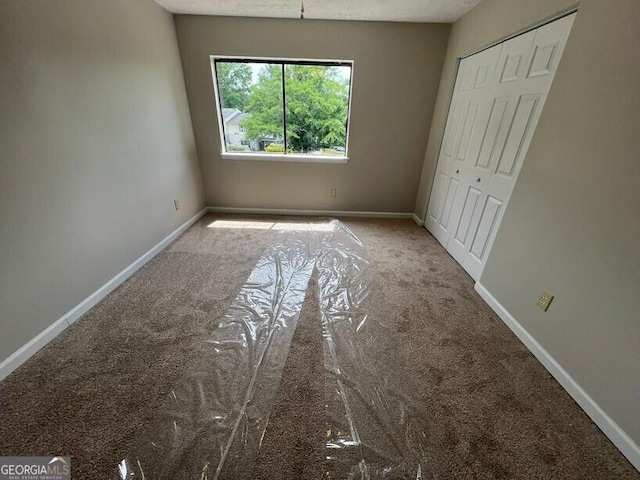 1466 Pine Log Rd NE Unit A, Conyers, GA 30012 - unfurnished bedroom with carpet floors, a closet, and baseboards