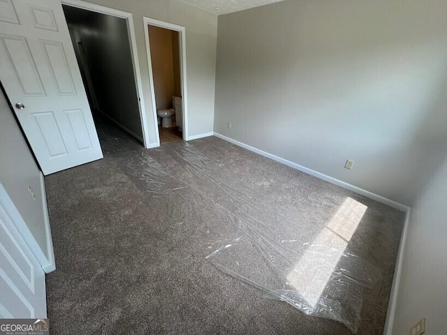 1466 Pine Log Rd NE Unit A, Conyers, GA 30012 - unfurnished bedroom featuring carpet flooring, ensuite bath, and baseboards