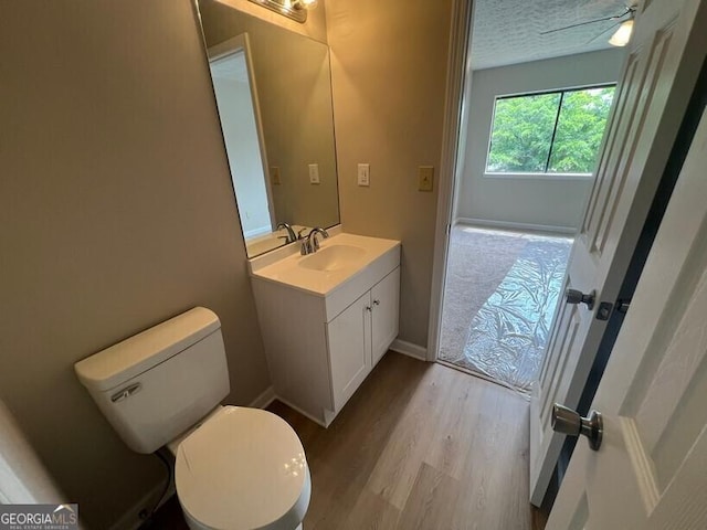 1466 Pine Log Rd NE Unit A, Conyers, GA 30012 - bathroom featuring toilet, baseboards, vanity, and wood finished floors