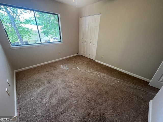 1466 Pine Log Rd NE Unit A, Conyers, GA 30012 - unfurnished bedroom featuring carpet, a closet, and baseboards