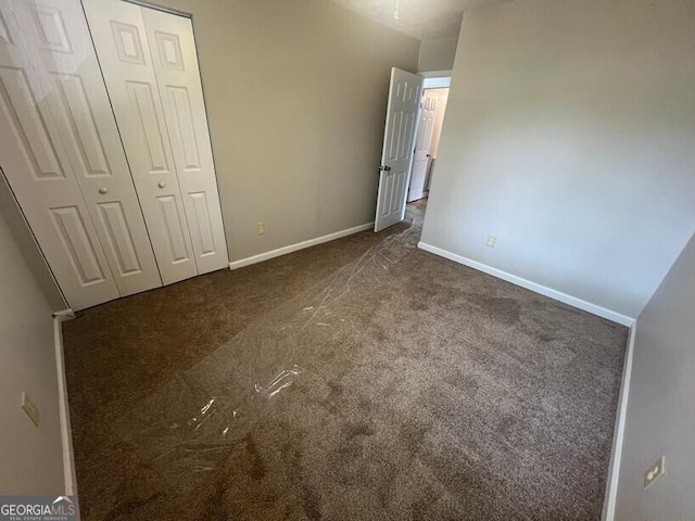 1466 Pine Log Rd NE Unit A, Conyers, GA 30012 - unfurnished bedroom featuring a closet, baseboards, and carpet floors