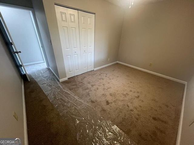 1466 Pine Log Rd NE Unit A, Conyers, GA 30012 - unfurnished bedroom with baseboards, carpet flooring, and a closet