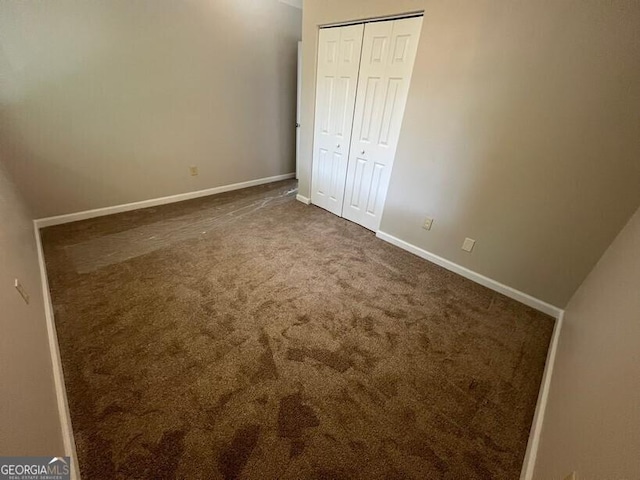 1466 Pine Log Rd NE Unit A, Conyers, GA 30012 - unfurnished bedroom with carpet floors, baseboards, and a closet
