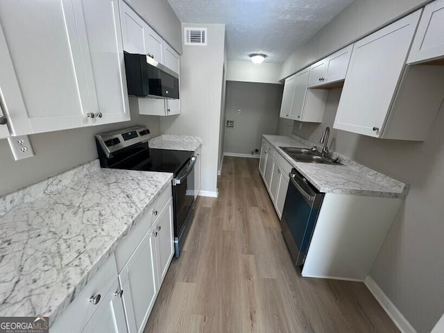 1466 Pine Log Rd NE Unit A, Conyers, GA 30012 - kitchen featuring a sink, light wood-type flooring, visible vents, baseboards, and appliances with stainless steel finishes