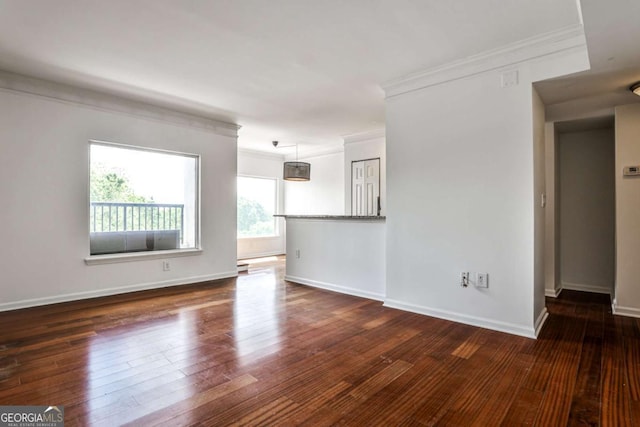 275 13th St NE Unit 605, Atlanta, GA 30309 - unfurnished living room with ornamental molding, hardwood / wood-style flooring, and baseboards