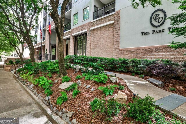 275 13th St NE Unit 605, Atlanta, GA 30309 - view of property exterior featuring stucco siding and stone siding