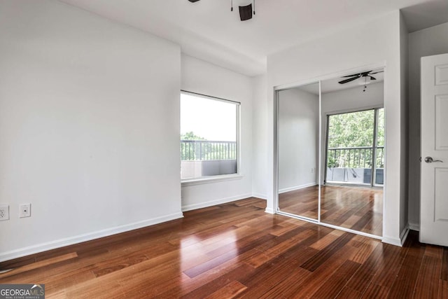 275 13th St NE Unit 605, Atlanta, GA 30309 - unfurnished bedroom with wood finished floors, baseboards, a ceiling fan, and a closet