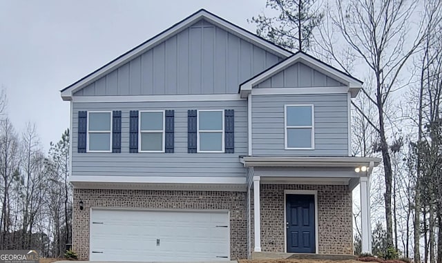 view of front of home featuring board and batten siding, a garage, brick siding, and driveway