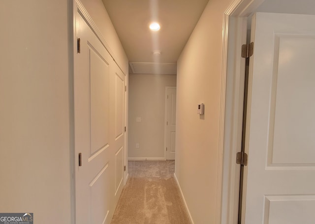 hallway with light carpet and baseboards