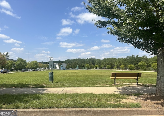 view of home's community with a yard and a view of trees
