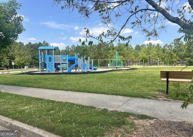 community jungle gym featuring a yard and fence