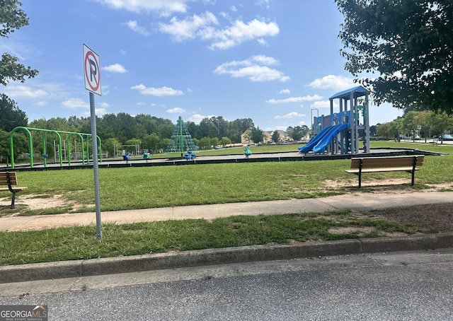 view of property's community featuring playground community and a lawn