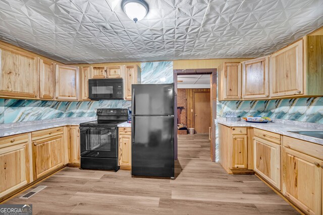 627 N Hulin Ave, Tignall, GA 30668 - kitchen featuring black appliances, light countertops, and light brown cabinetry