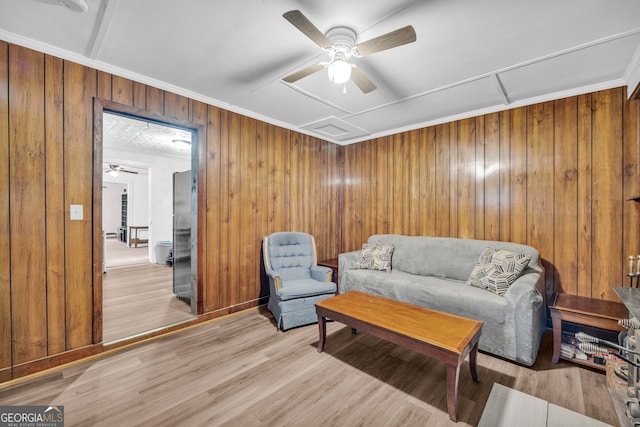 627 N Hulin Ave, Tignall, GA 30668 - living room with wood walls, light wood-style flooring, and ceiling fan