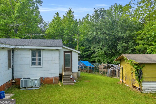 627 N Hulin Ave, Tignall, GA 30668 - exterior space with central air condition unit, entry steps, an outbuilding, and fence