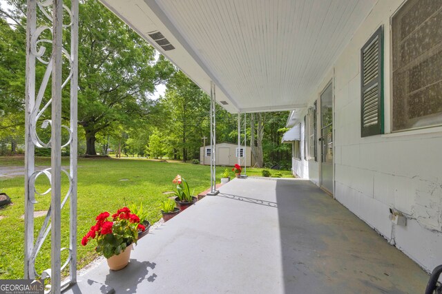 627 N Hulin Ave, Tignall, GA 30668 - view of patio featuring an outbuilding and a storage unit