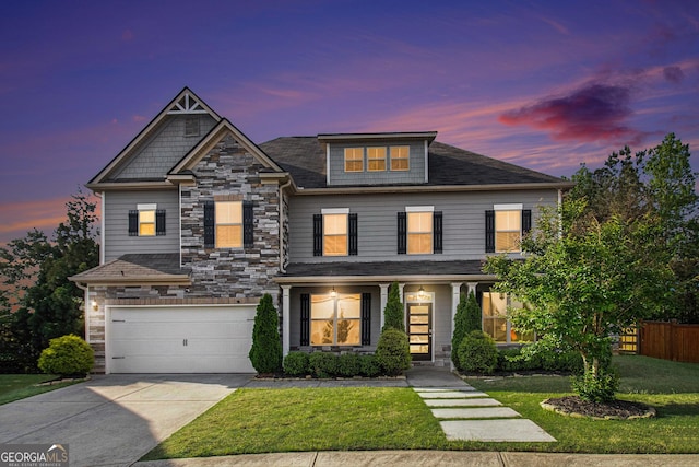 2113 Dodson Woods Dr, Fairburn, GA 30213 - craftsman-style home with stone siding, an attached garage, fence, a lawn, and concrete driveway